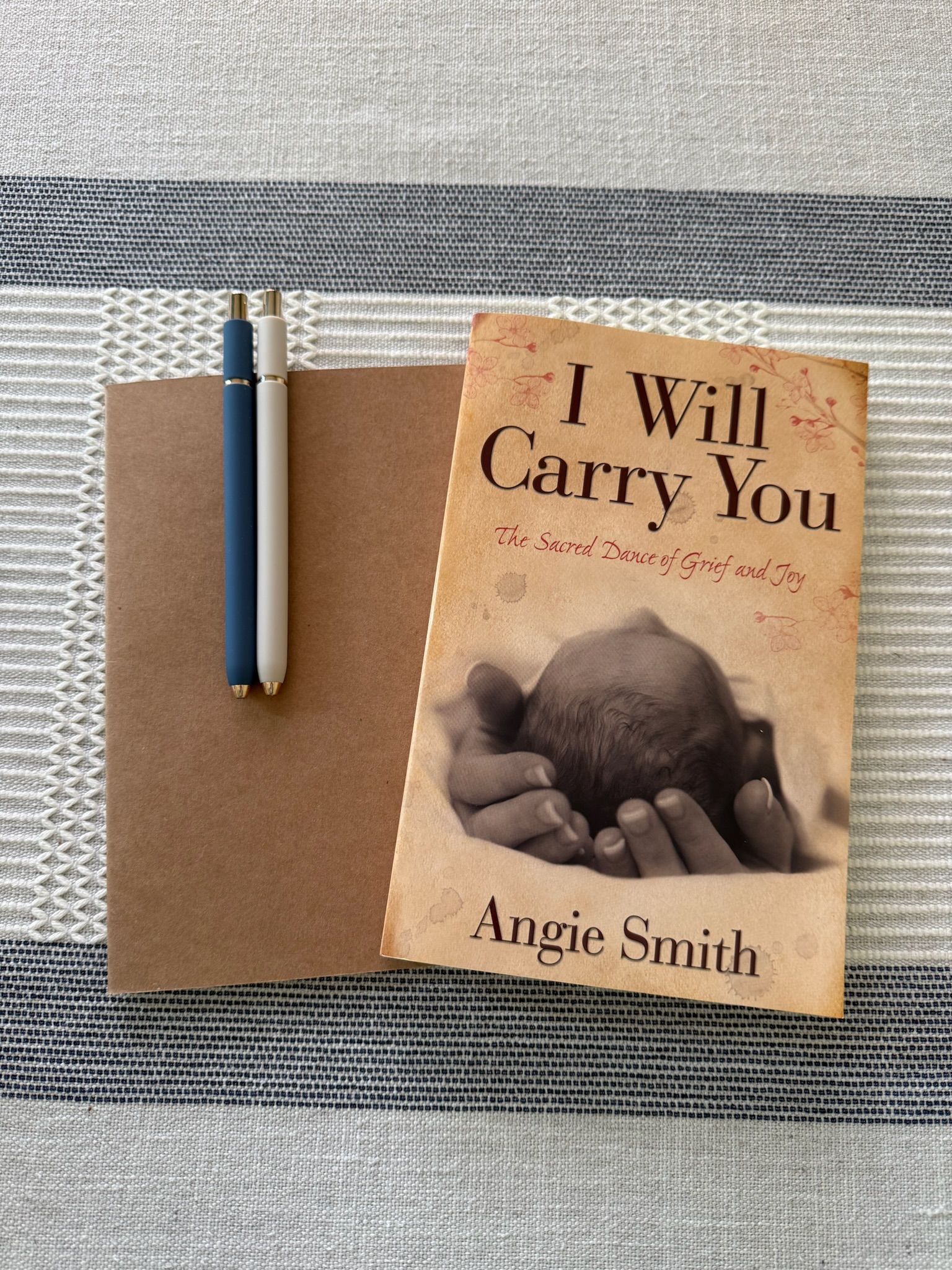 I Will Carry You book, journal, and pens